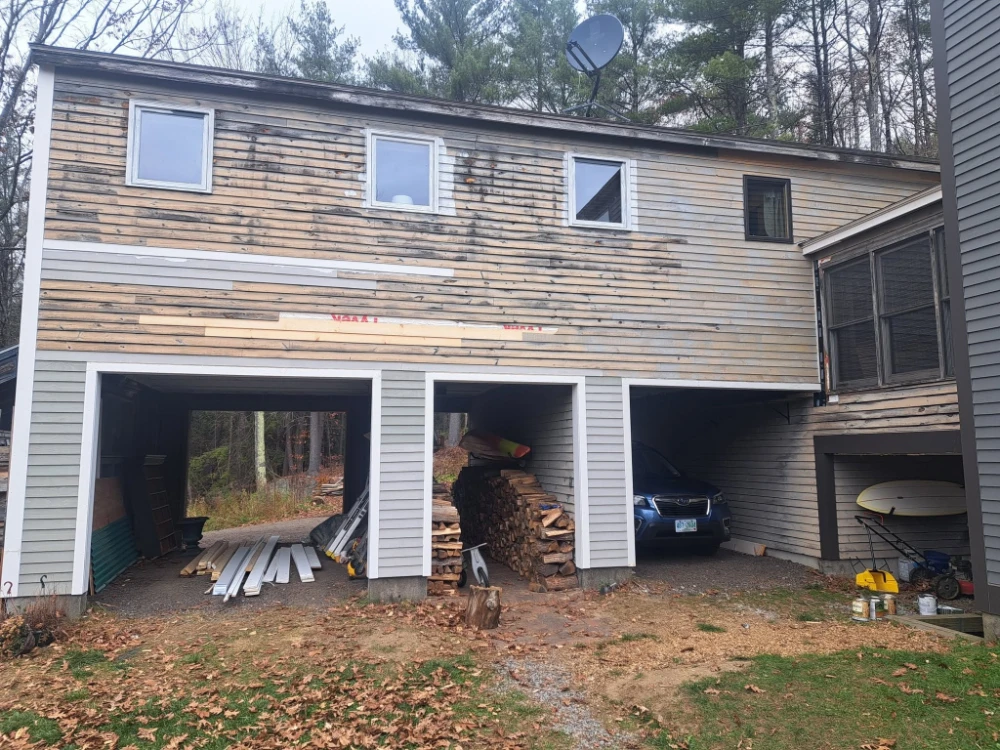 Siding and trim work underway on a New Hampshire home