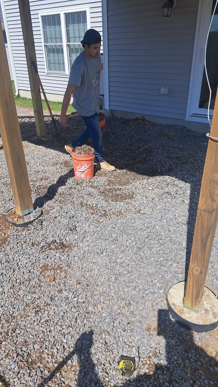 Deck framing posts set in a backyard during a new deck build