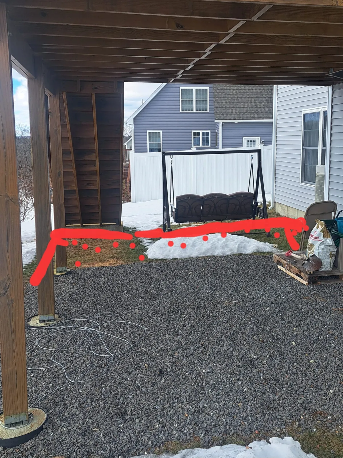Covered patio beneath an elevated deck