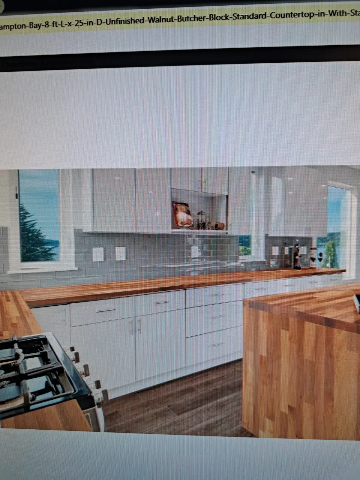 Kitchen with a tile backsplash and butcher block counters