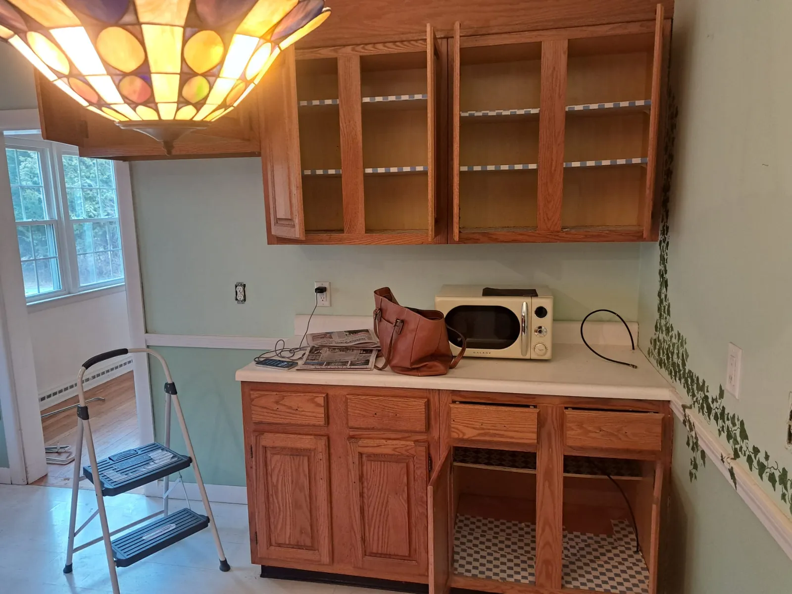 Kitchen mid-remodel with cabinets prepped for paint