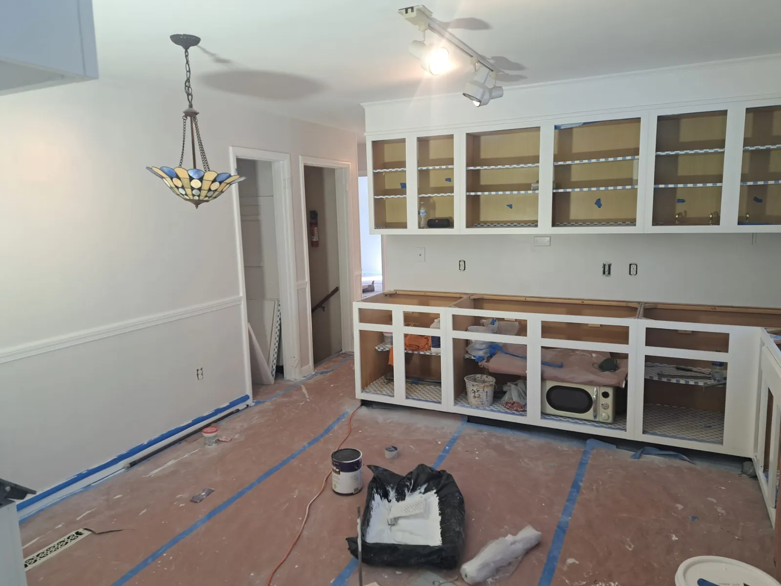 Bright open room freshly painted white with built-in cabinetry