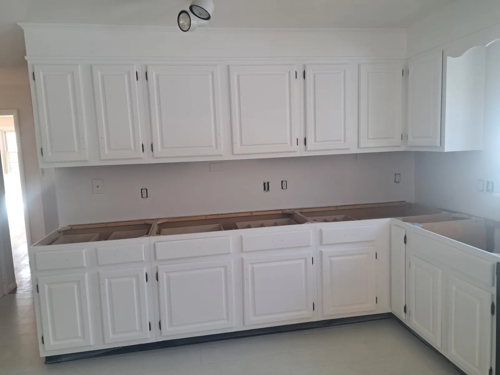 White built-in cabinets after finish carpentry and paint