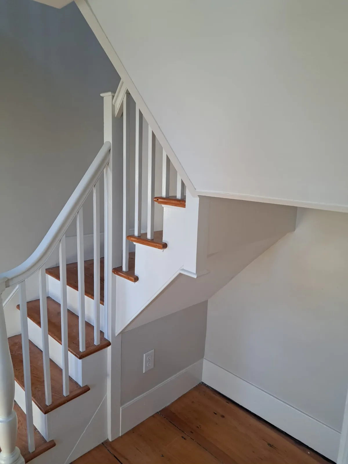 White staircase and railing after finish carpentry