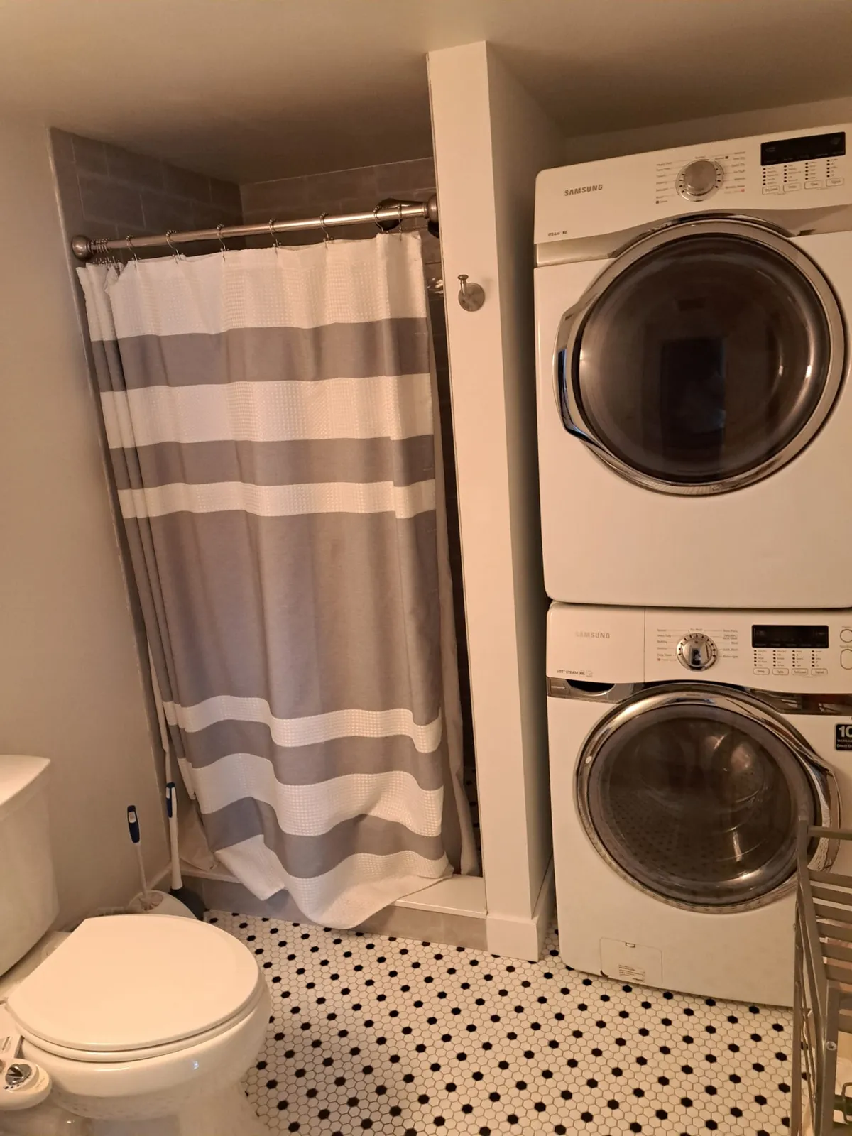 Bathroom with a stacked washer and dryer after a remodel