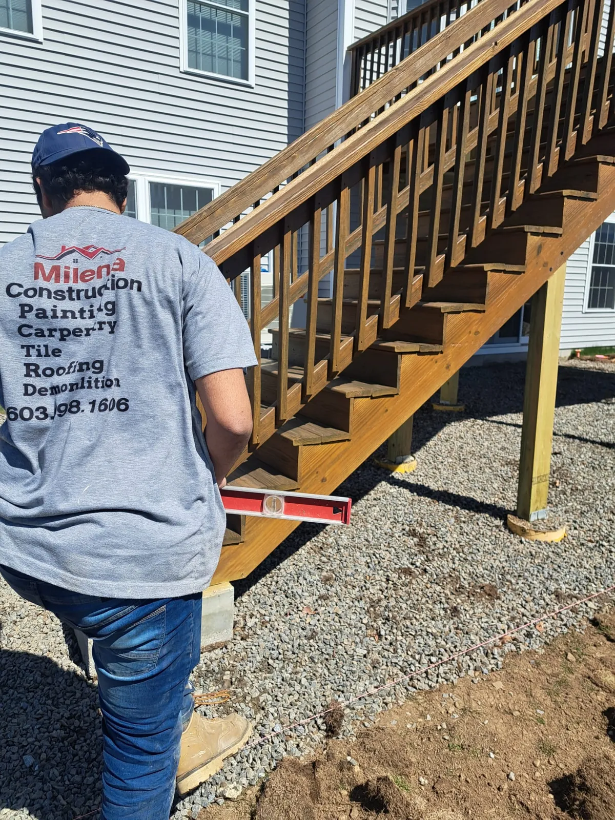 A Milena Construction crew member building deck stairs