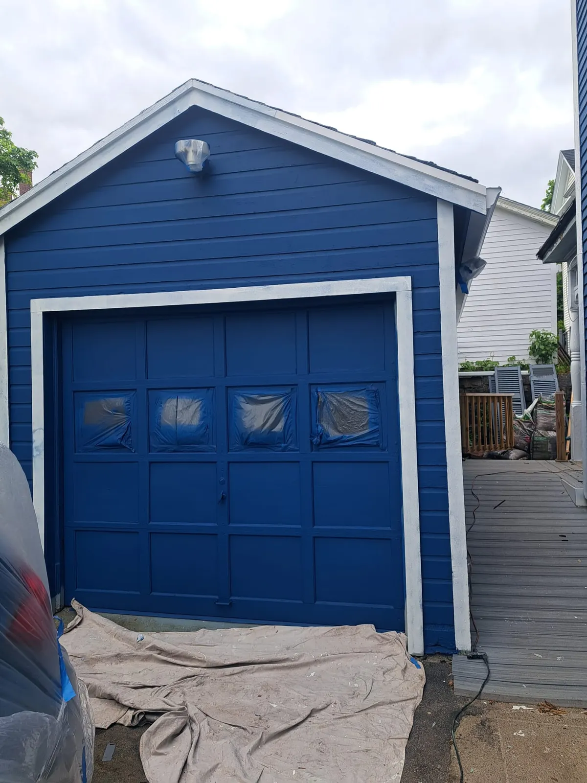 Freshly painted blue garage with white trim