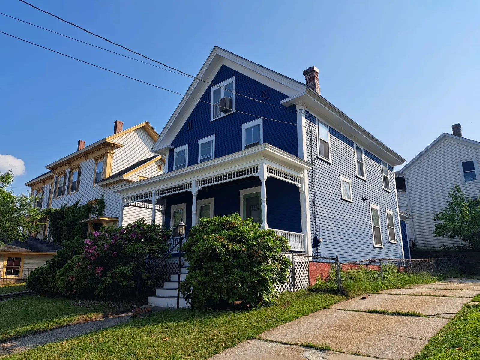 Blue clapboard home with fresh exterior paint and white trim