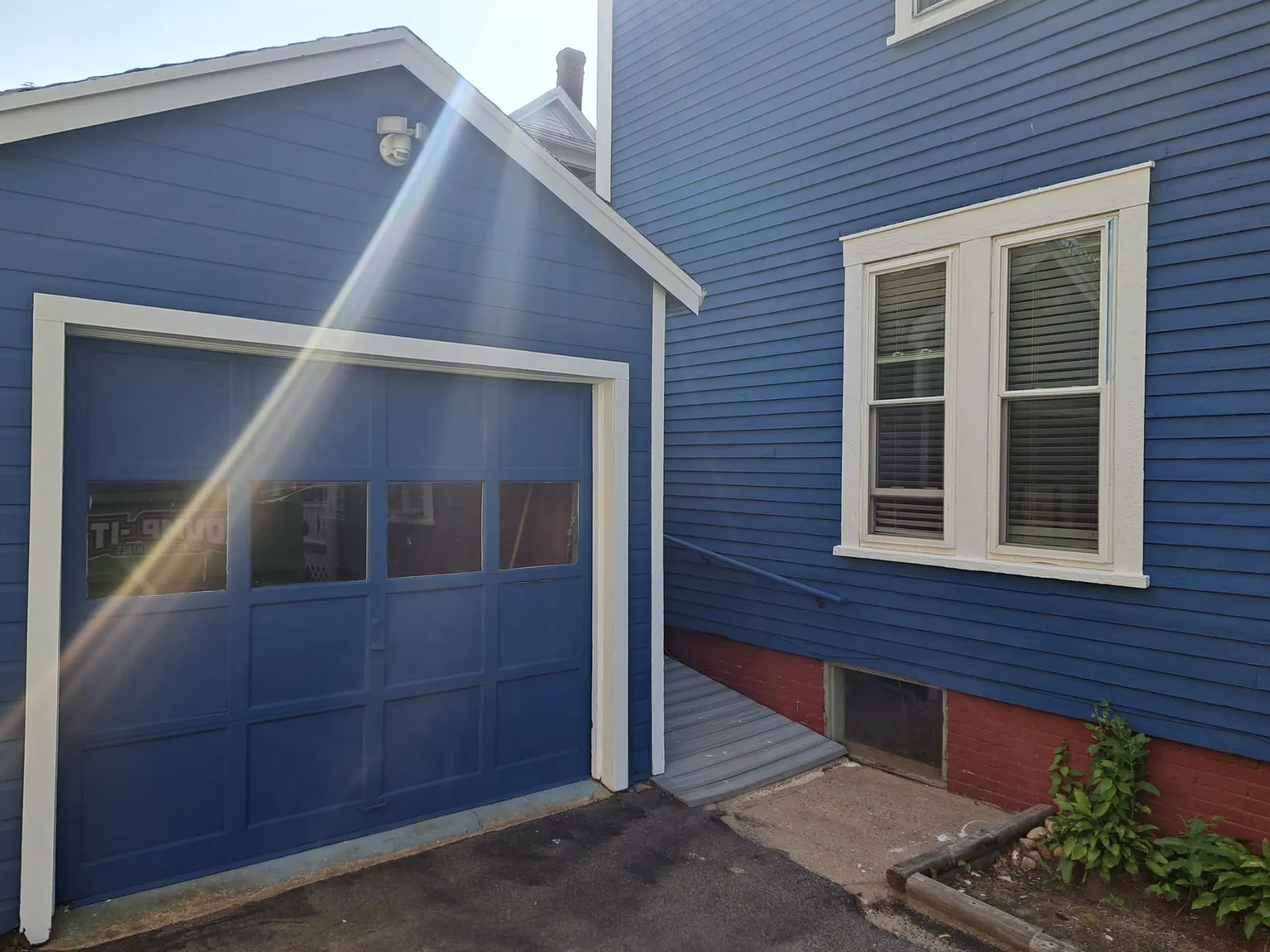 Blue garage and siding after an exterior repaint