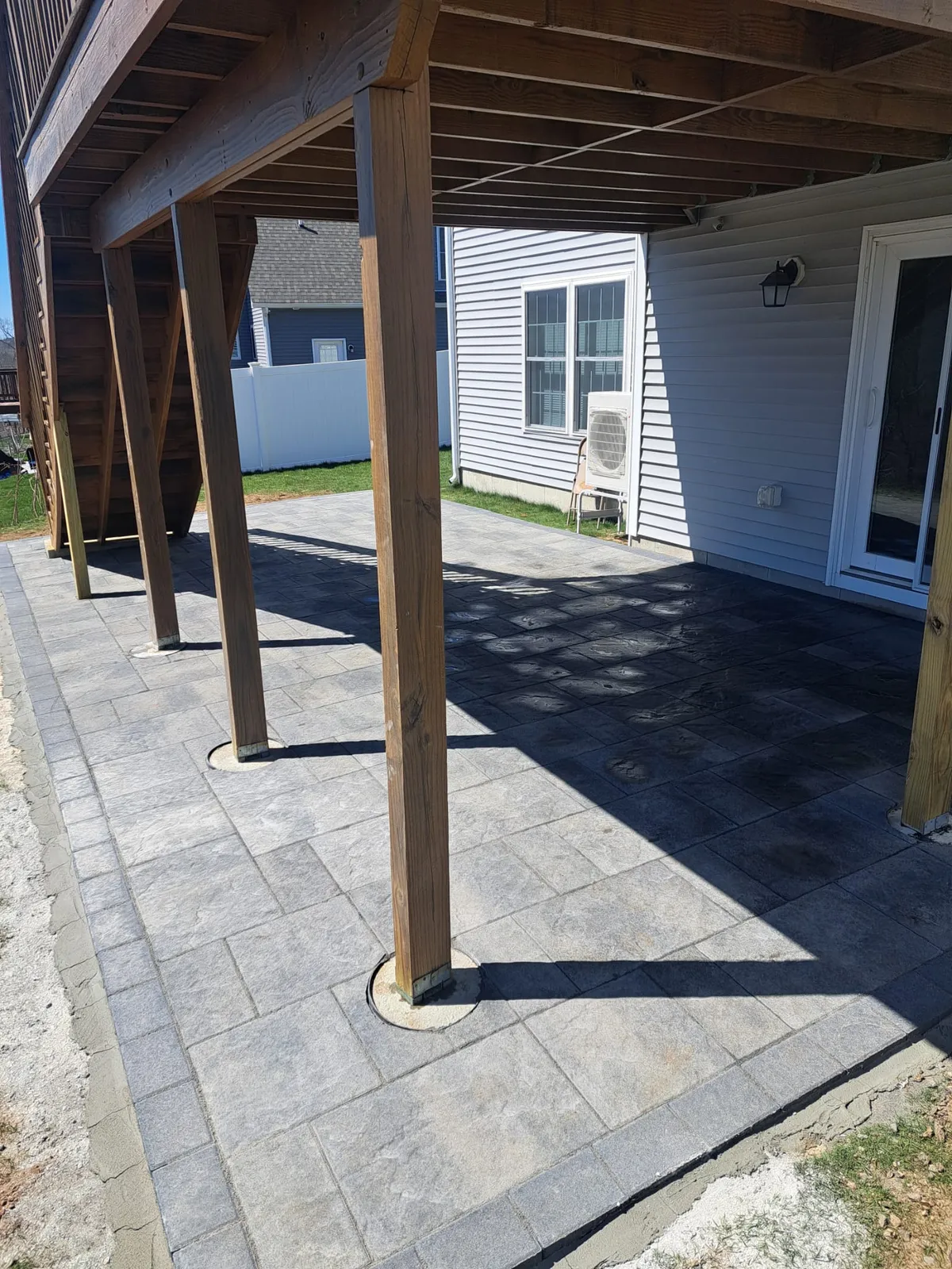 Paver patio beneath a covered deck