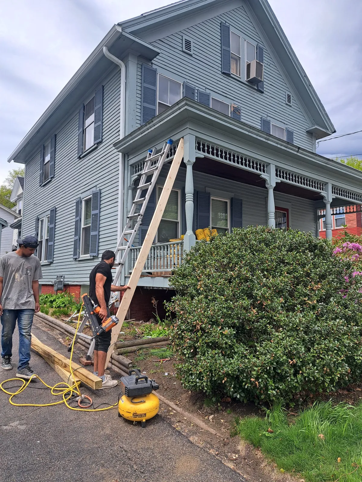 Exterior repaint underway on a gray multifamily home