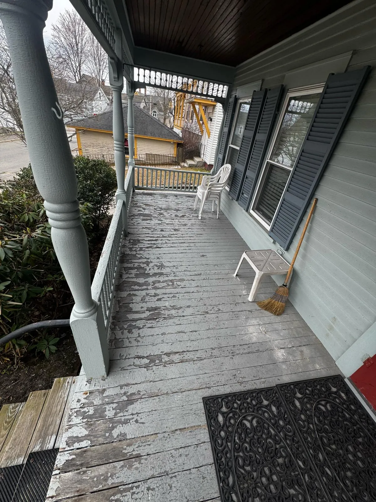 Gray porch steps and railing after restoration