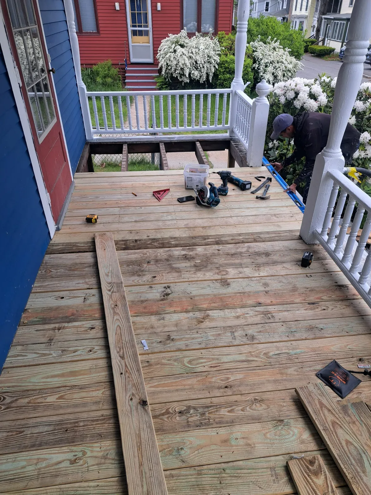 New wood deck with white porch railings