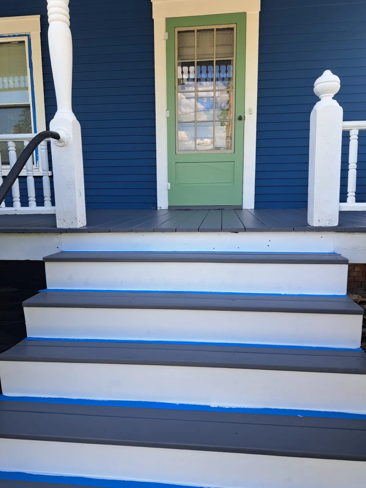 Painted porch steps with a green front door