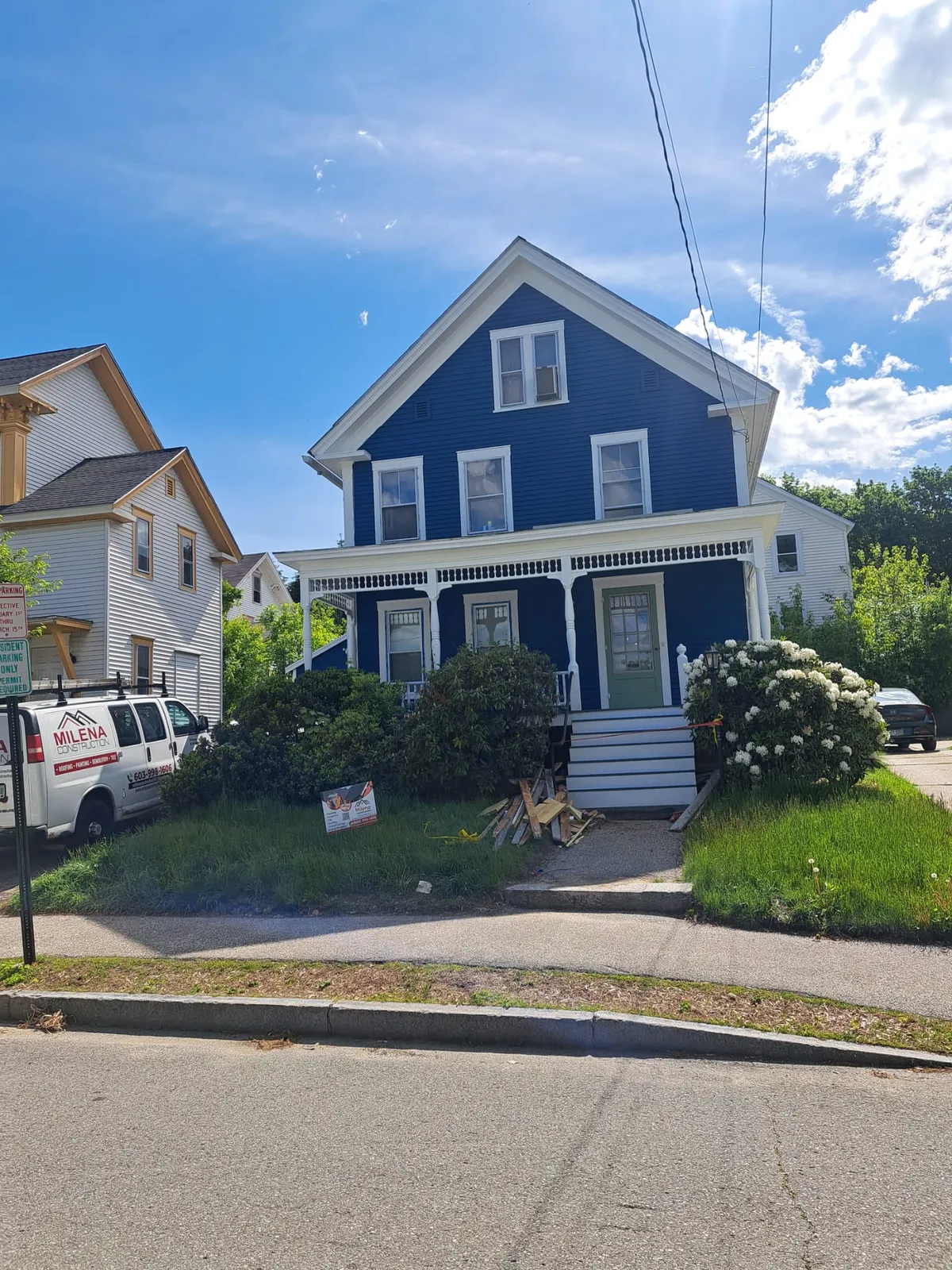 Freshly painted blue two-story home viewed from the street