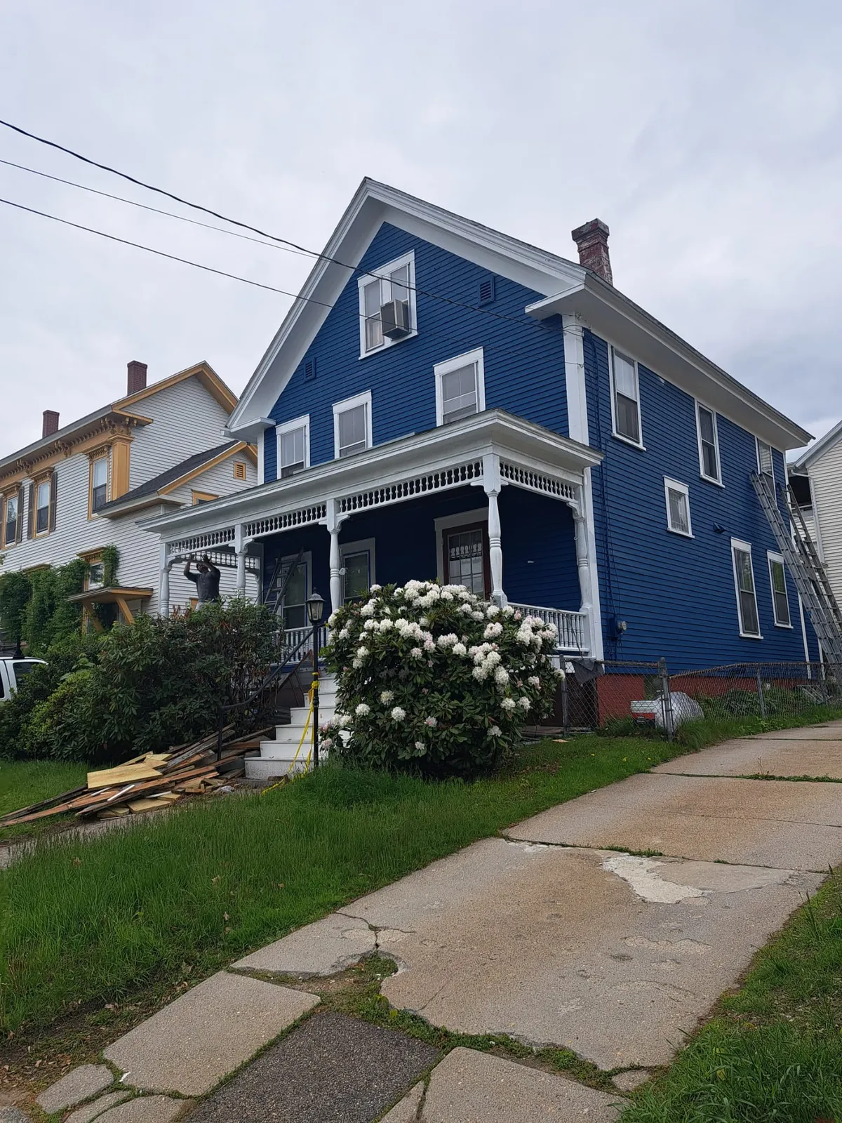 Deep blue two-story home repainted with crisp white trim in Southern New Hampshire