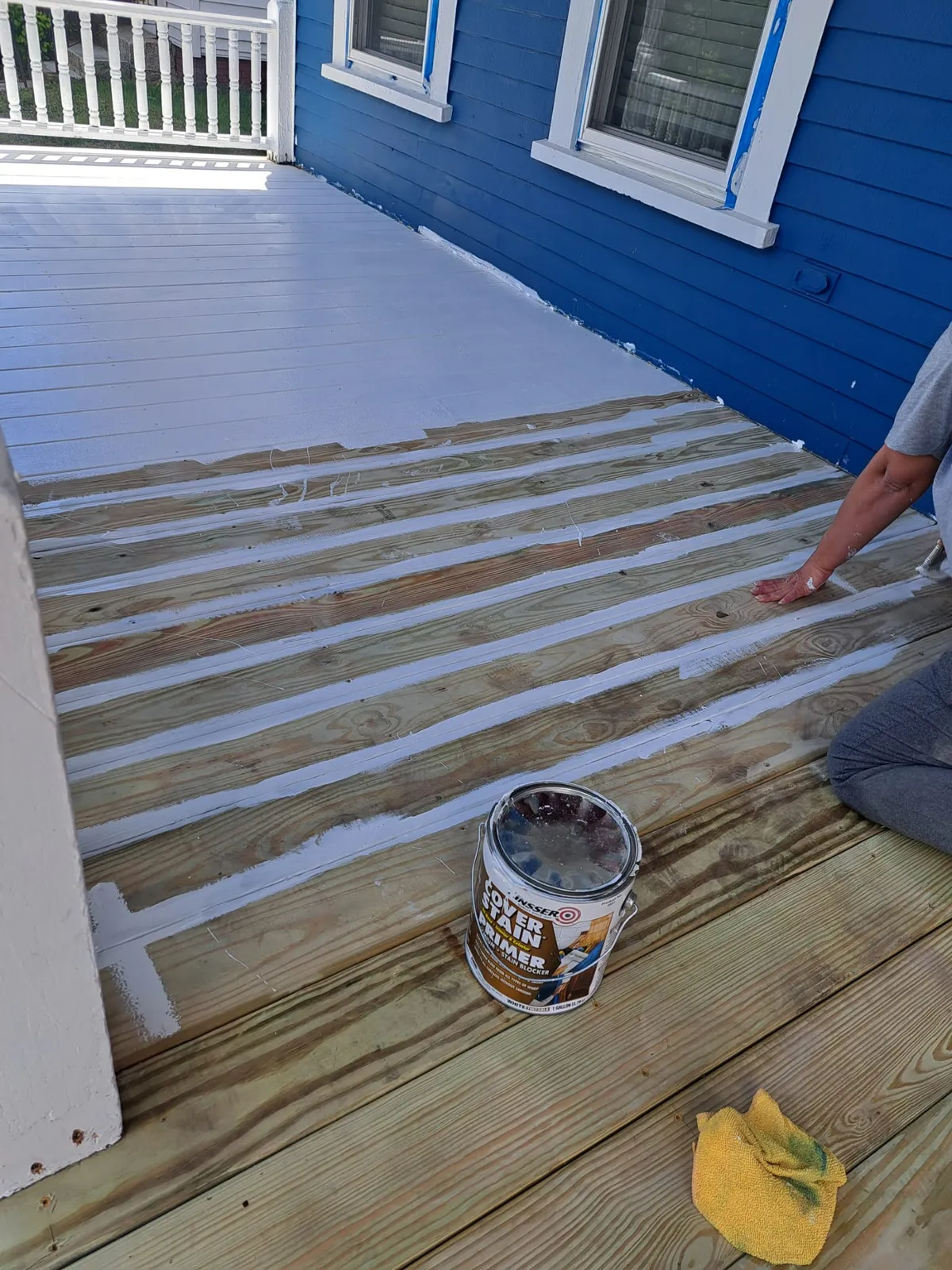 Deck being coated with gray solid stain