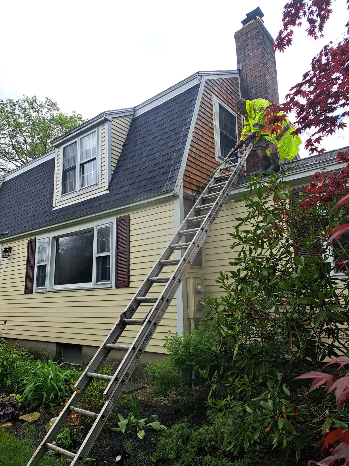 Exterior work in progress on a yellow home