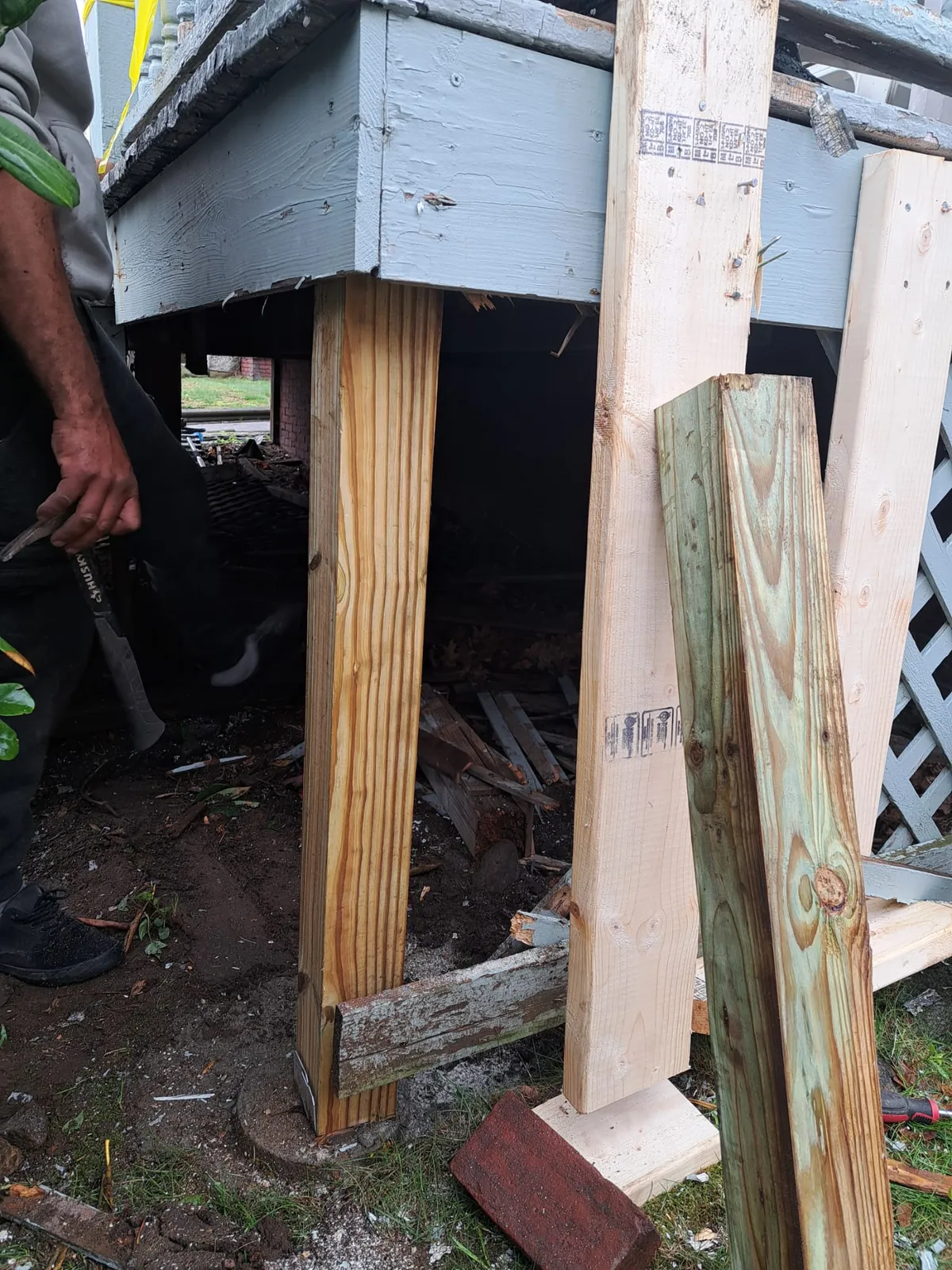 Structural post repair beneath a deck