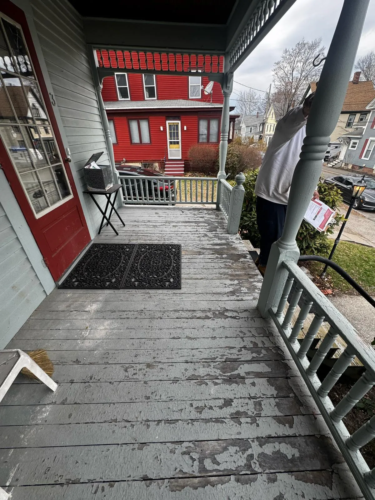 Gray deck and steps with a red door