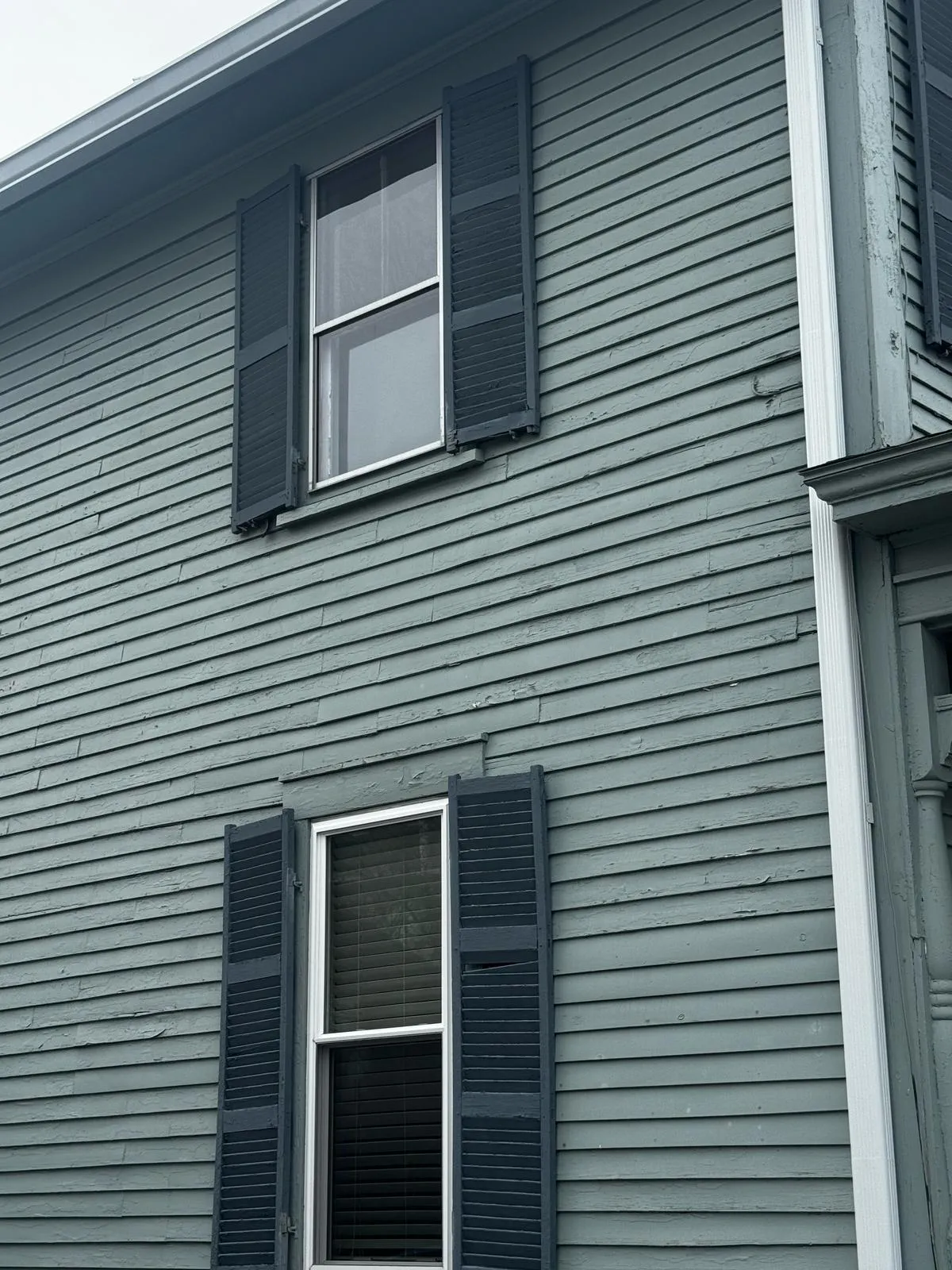 Side of a blue-gray home with fresh exterior paint