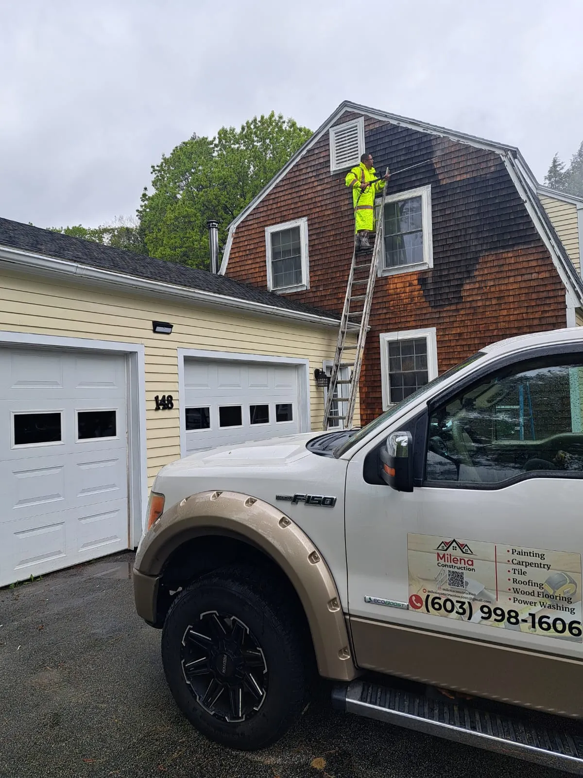 Milena Construction truck at a garage exterior project