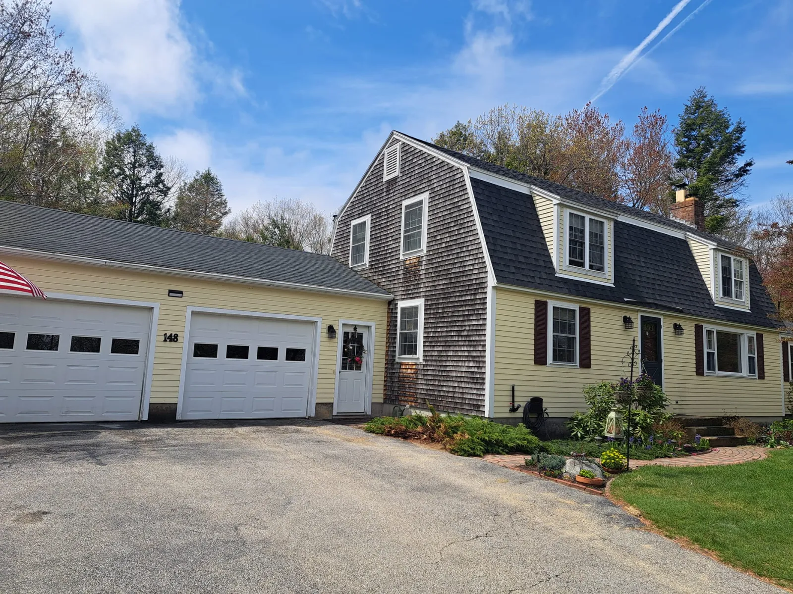 Cedar-shingle cape home with a two-car garage