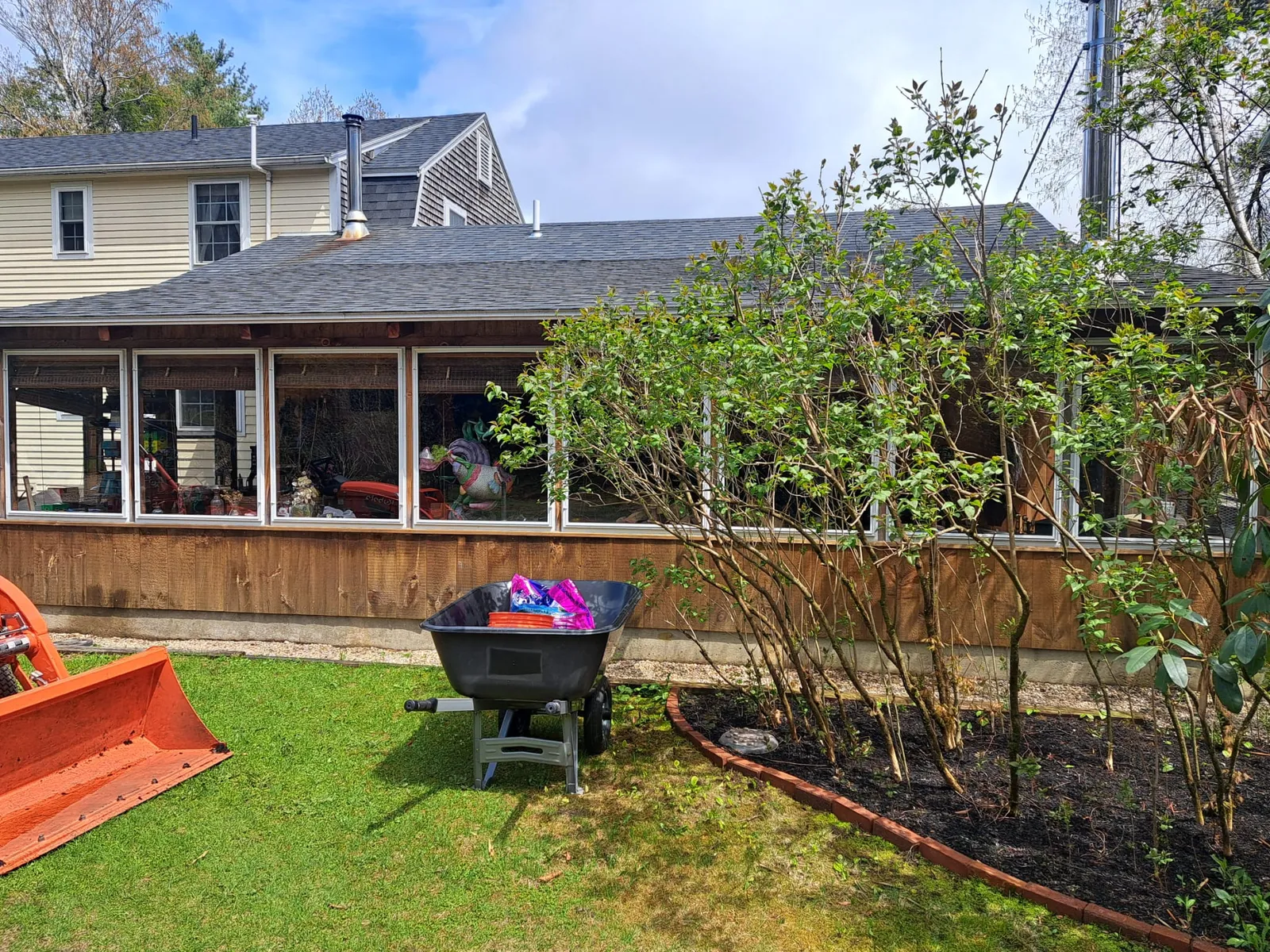 Home with a screened sunroom and a landscaped backyard