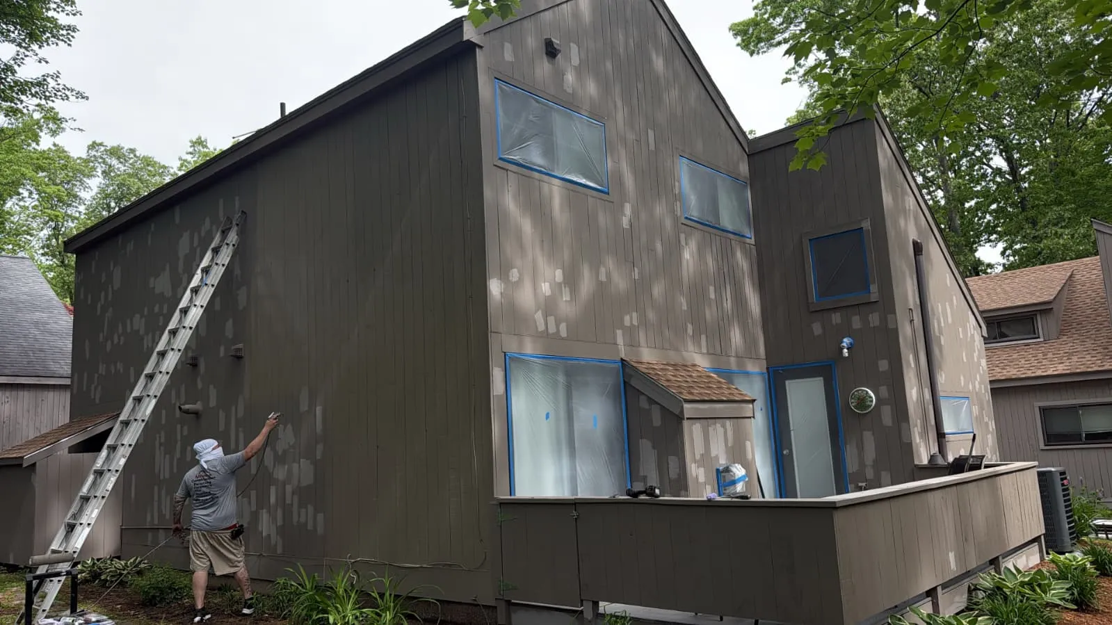 Exterior painting underway on a contemporary home