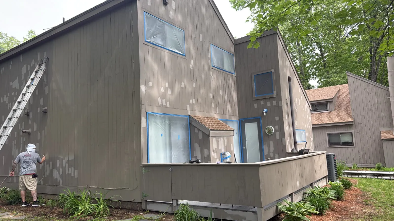 Crew member priming a contemporary home exterior