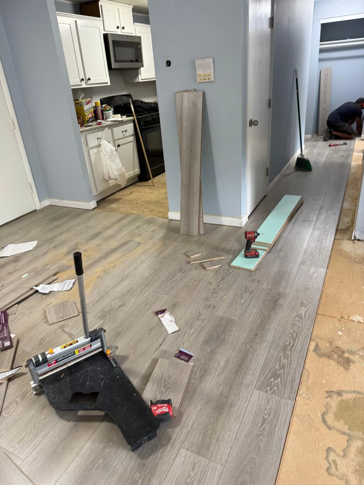 Luxury vinyl plank installation underway in a kitchen