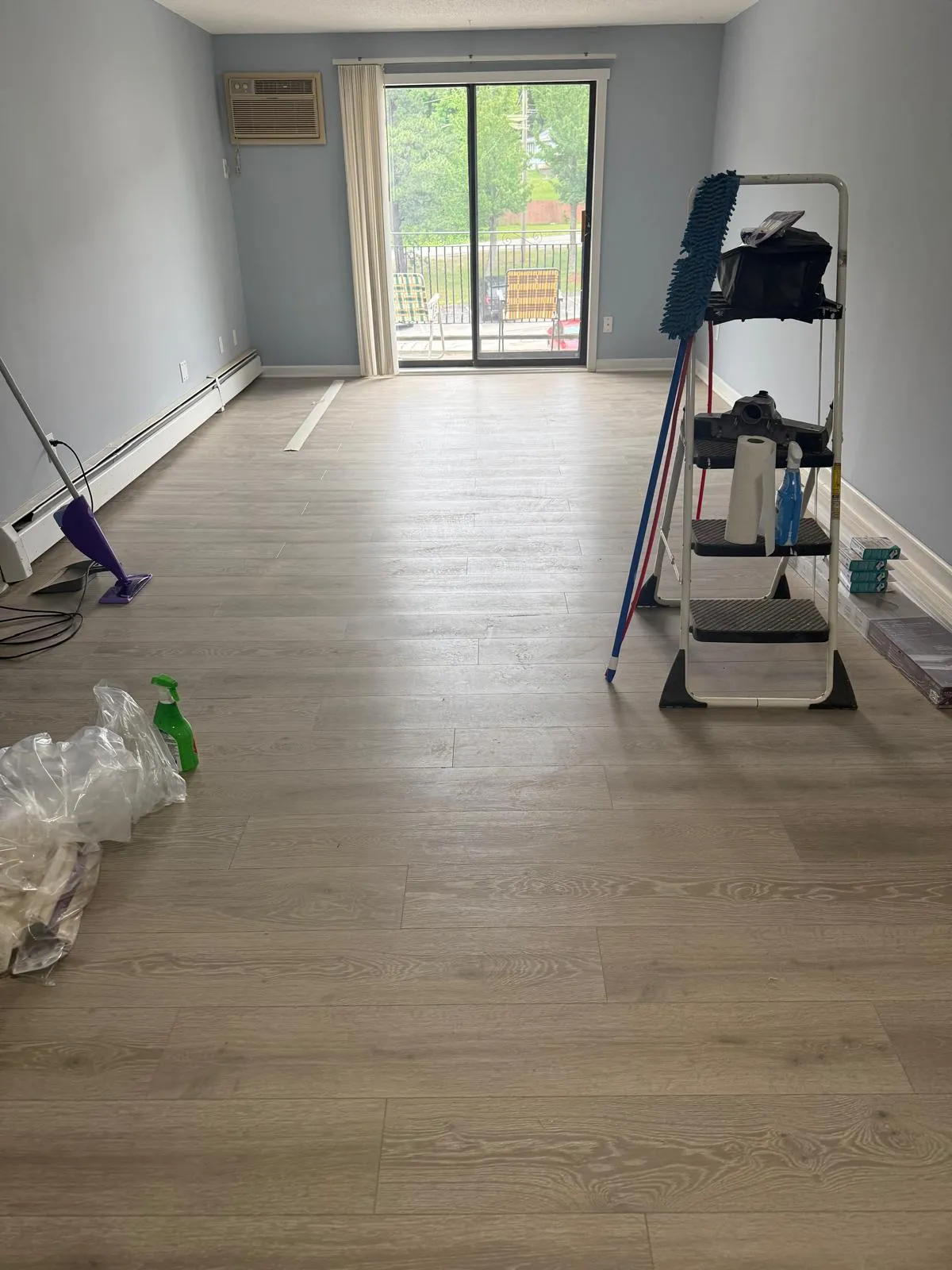 Room mid-installation with new vinyl plank flooring
