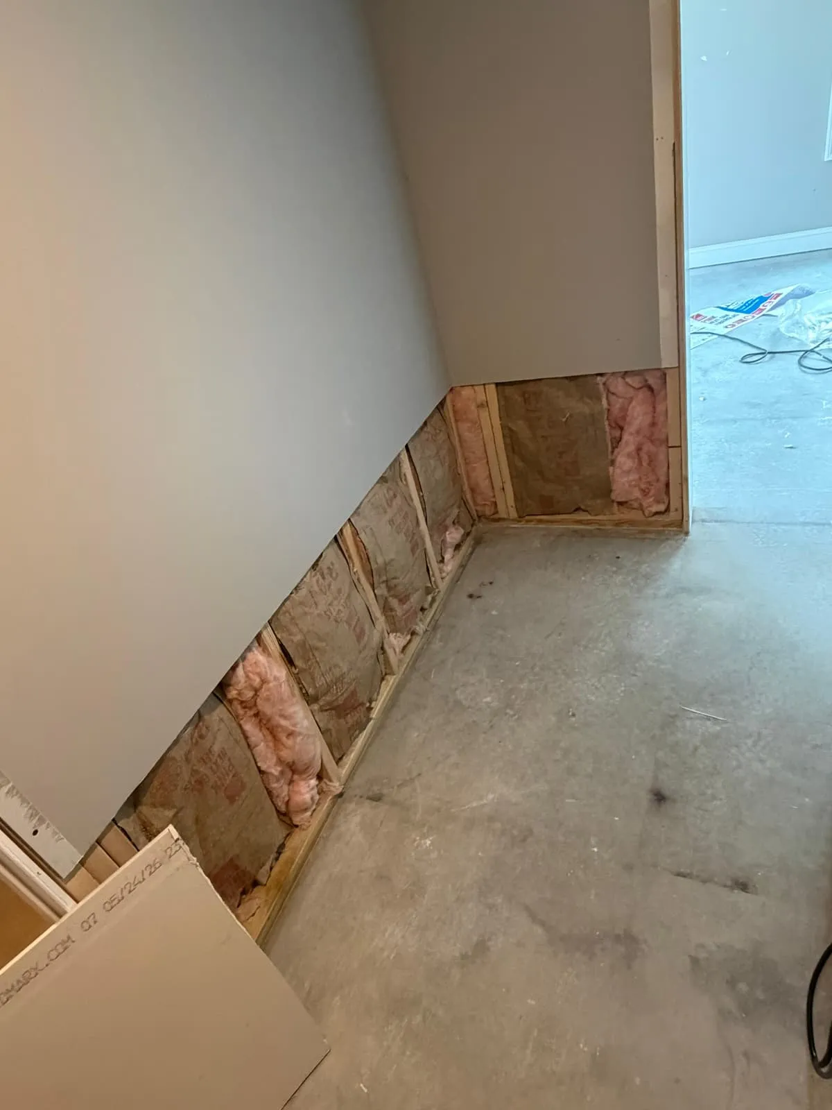 Baseboard and flooring transition being finished
